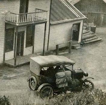 old picture of jeep near station