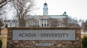 Acadia University sign with Acadia University in background